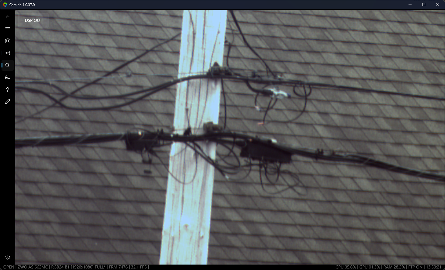 Raw live camera frame showing a rooftop and utility pole